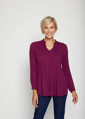 Pleated blouse with frilly collar